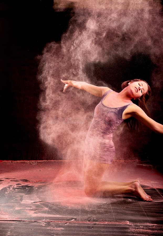 Dancer expressing pink powder