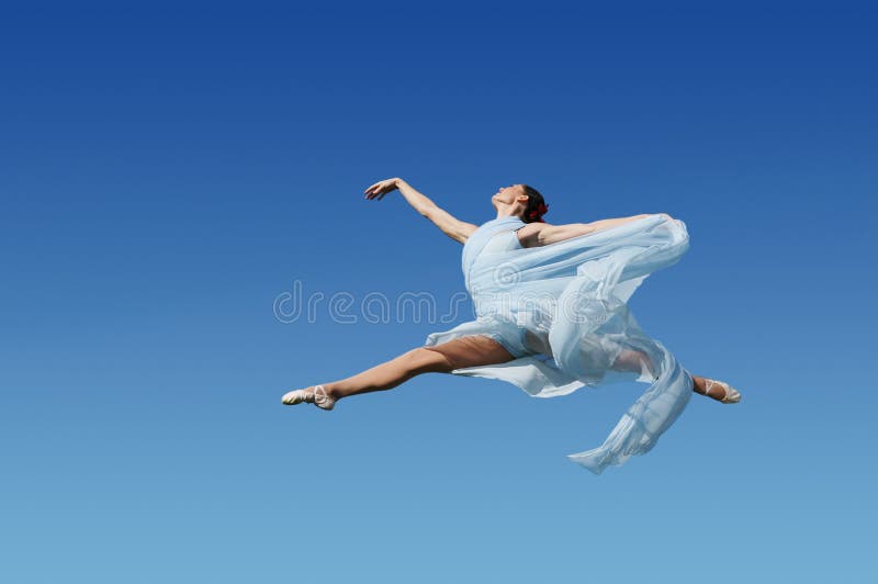 Dancer jumping against blue sk