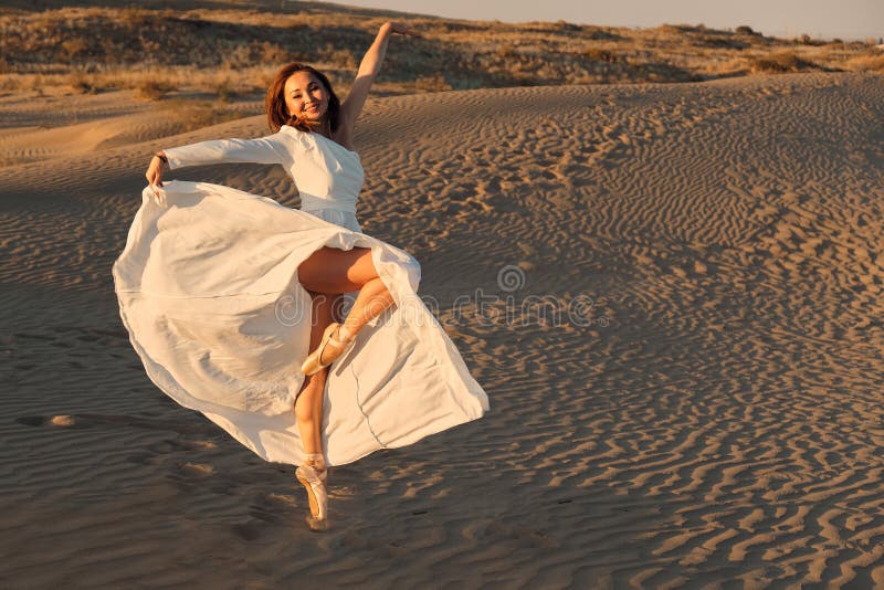 Dances in the desert in white dress