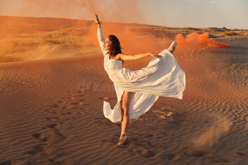 Dances in the desert in white dress