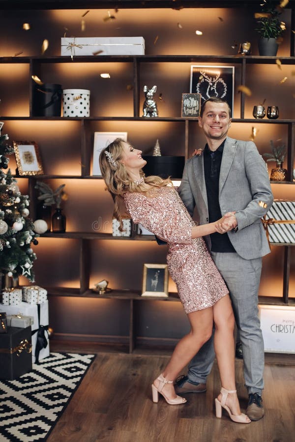 Dancing couple at Christmas under confetti.New Year stock image Dancing couple at Christmas under confetti.New Year stock image