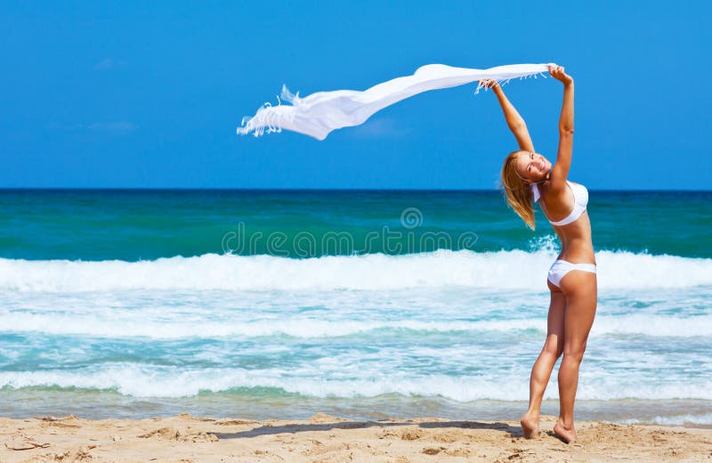 Dancing happy girl on the beach