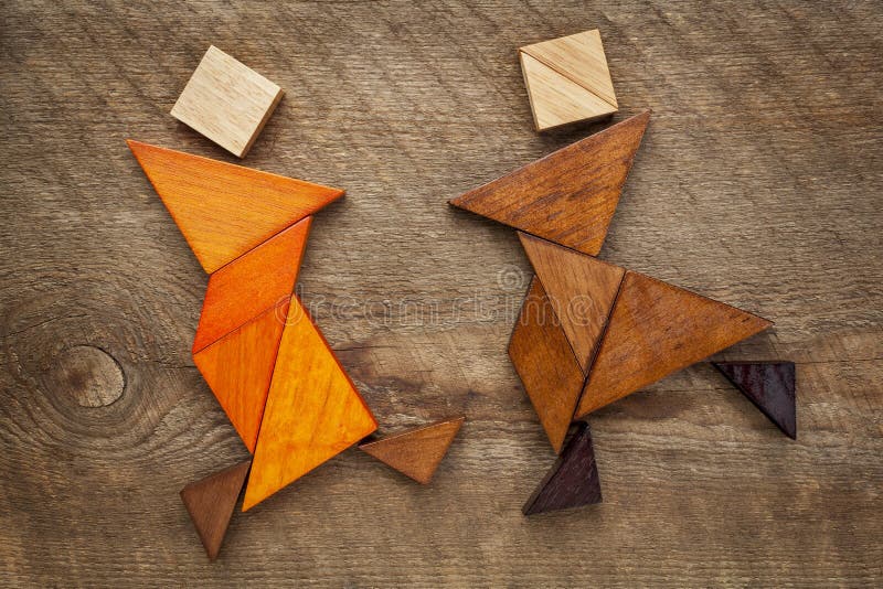 A couple of dancers or martial artists - abstract figures built from tangram wooden pieces, a traditional Chinese puzzle game. A couple of dancers or martial artists - abstract figures built from tangram wooden pieces, a traditional Chinese puzzle game