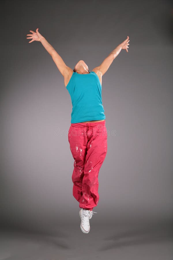 Dancing woman in sportswear jumps