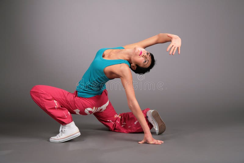 Dancing woman in sportswear poses