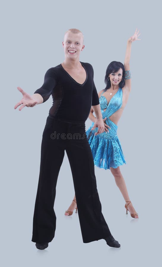 Dancing young couple isolated on a gray background.