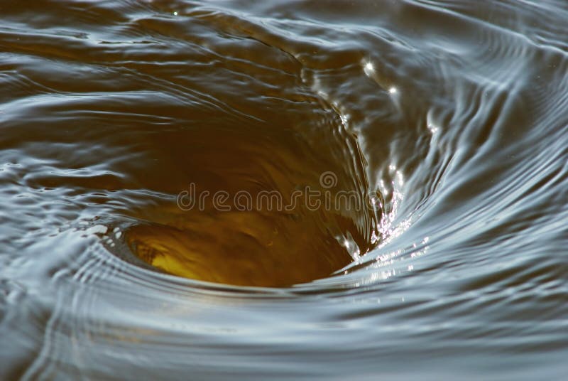A swirling vortex in water. Whirlpool vortex water stock images, royalty-free photos and pictures