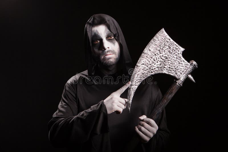 Dangerous scary man dressed up like grim reaper