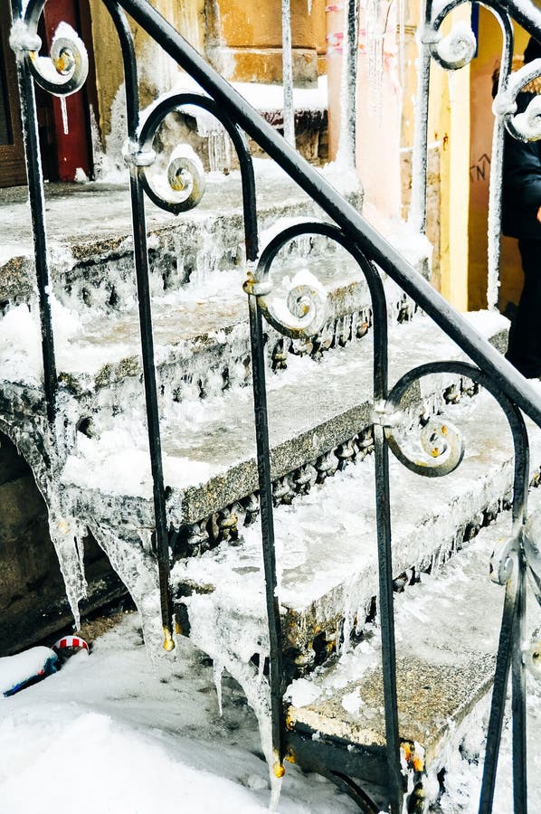 Dangerous step vertical ladder covered with icicles.  stock photo