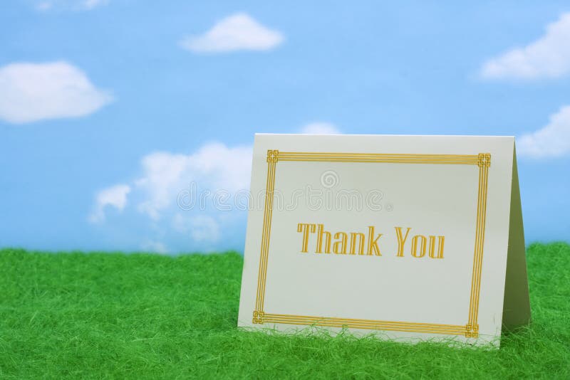 Thank you card on grass with copy space. Thank you card on grass with copy space