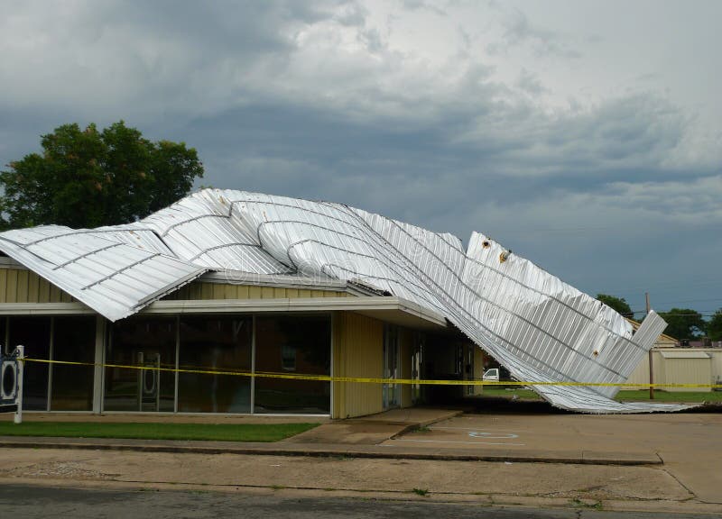 Yellow police tape surrounds this building following a severe storm that lifted and removed a metal roof. Repairs will be underway. Yellow police tape surrounds this building following a severe storm that lifted and removed a metal roof. Repairs will be underway.