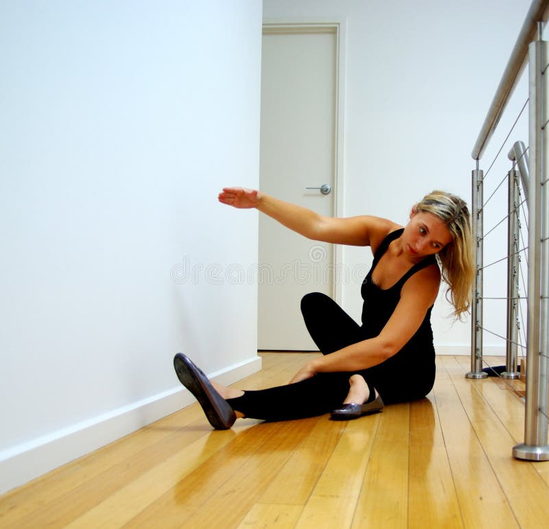 Photograph taken featuring a woman preparing for a dancing class by stretching (Adelaide, Australia). Photograph taken featuring a woman preparing for a dancing class by stretching (Adelaide, Australia).