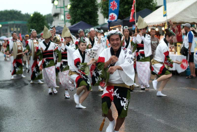 Awa odori is part of the Bon festivities, which are held to welcome one's ancestors back to this world for a few days. Though Bon dances are usually performed in a circle, Awa odori participants march in a straight line. They march through the streets in unison to music performed on the shamisen, flute, drums, and bells singing Odoru aho ni miru aho; onaji aho nara odoranya son son! (It's a fool who dances and a fool who watches; if both are fools, you might as well dance!).Because of this chant, Awa odori is sometimes called the fool's dance. The movements are really simple; all you have to do is keep your legs and arms moving forward with as much vigor as possible. Men dance in tabi (split-toed, rubber-soled socks), while women wear sandals, their heels not touching the ground. One rule you have to observe is to keep your hands and arms above your shoulder while dancing. This is quite unusual, since most dancing styles in Japan emphasize downward motion. Awa odori is upward oriented.The dancing style is believed to have been invented one night in 1585, when construction of a new castle for the lord of the Awa domain was completed. During the party held to celebrate the new castle, people got so drunk that they started dancing with their arms and legs flailing.A lot of events take place around the country during the Bon season in mid-August, and Awa odori is among the most famous. Awa odori is part of the Bon festivities, which are held to welcome one's ancestors back to this world for a few days. Though Bon dances are usually performed in a circle, Awa odori participants march in a straight line. They march through the streets in unison to music performed on the shamisen, flute, drums, and bells singing Odoru aho ni miru aho; onaji aho nara odoranya son son! (It's a fool who dances and a fool who watches; if both are fools, you might as well dance!).Because of this chant, Awa odori is sometimes called the fool's dance. The movements are really simple; all you have to do is keep your legs and arms moving forward with as much vigor as possible. Men dance in tabi (split-toed, rubber-soled socks), while women wear sandals, their heels not touching the ground. One rule you have to observe is to keep your hands and arms above your shoulder while dancing. This is quite unusual, since most dancing styles in Japan emphasize downward motion. Awa odori is upward oriented.The dancing style is believed to have been invented one night in 1585, when construction of a new castle for the lord of the Awa domain was completed. During the party held to celebrate the new castle, people got so drunk that they started dancing with their arms and legs flailing.A lot of events take place around the country during the Bon season in mid-August, and Awa odori is among the most famous.