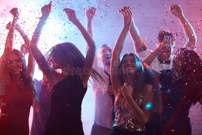 Ecstatic friends dancing in confetti rain. Ecstatic friends dancing in confetti rain
