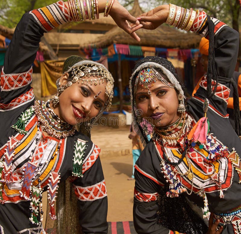 Beautiful Kalbelia dancers in ornate black costumes trimmed with beads and sequins at the annual Sarujkund Fair near Delhi, India. Beautiful Kalbelia dancers in ornate black costumes trimmed with beads and sequins at the annual Sarujkund Fair near Delhi, India.