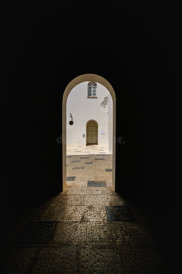 Dar wall with arch type doorway and a door in the distance on a sunny day royalty free stock images Dar wall with arch type doorway and a door in the distance on a sunny day royalty free stock images