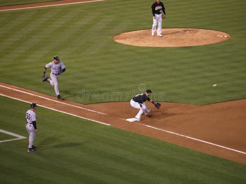 Yankees 6 vs A's 2: As Daric Barton reachs down to catch ball before running Yankees Derek Jeter reaches 1st base. July 7 2010 at the Coliseum in Oakland California. Yankees 6 vs A's 2: As Daric Barton reachs down to catch ball before running Yankees Derek Jeter reaches 1st base. July 7 2010 at the Coliseum in Oakland California