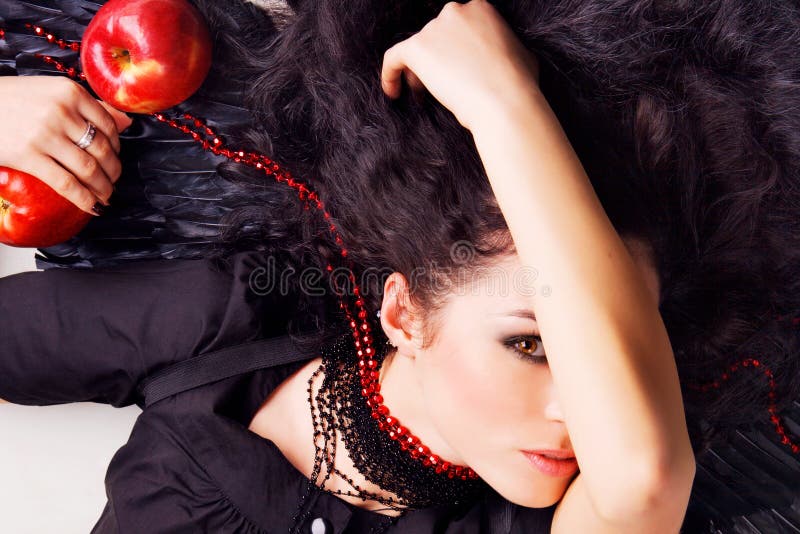 Dark angel girl with red apples