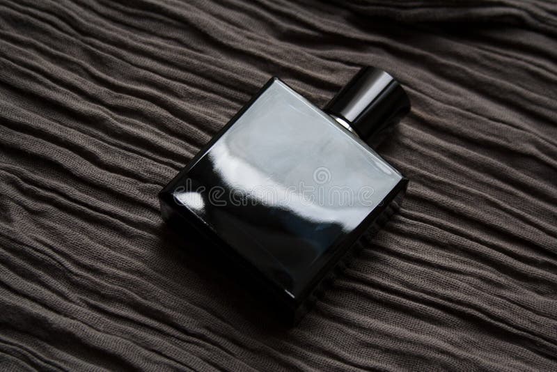 Dark Blue Perfume Bottle on Textured Fabric Stock Image - Image of