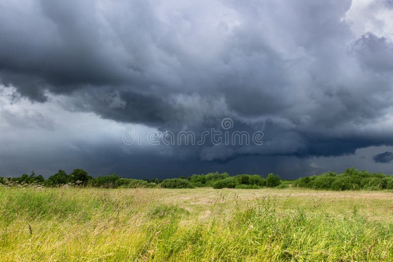 Dark Blue Sky And Green Field Before Thunderstorm