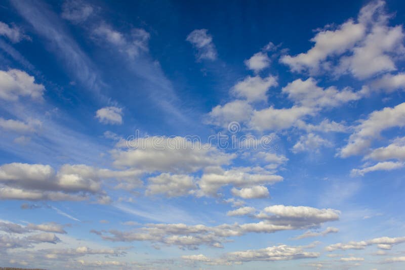 Dark blue sky with lots of white silver clouds stock image Dark blue sky with lots of white silver clouds stock image