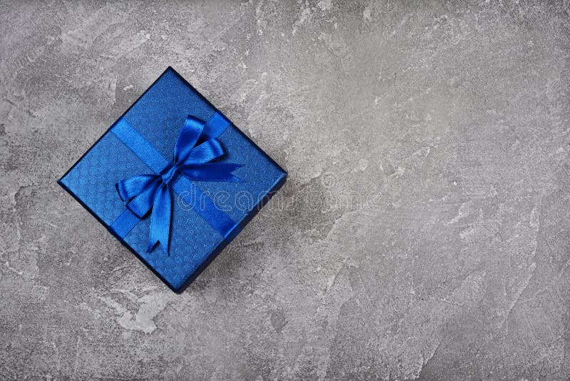 Dark blue square gift box with shiny satin bow royalty free stock photo Dark blue square gift box with shiny satin bow royalty free stock photo