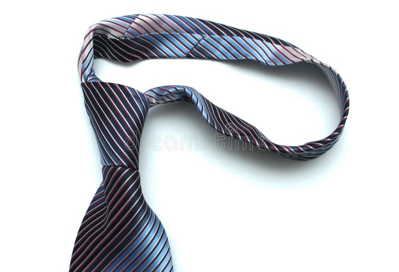 The dark blue tie lays on a white background