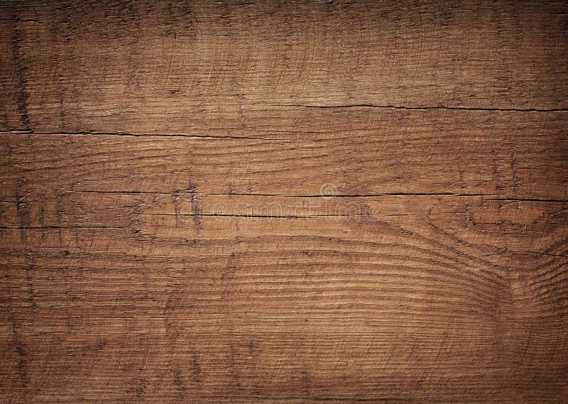 Dark brown scratched wooden cutting board. Wood