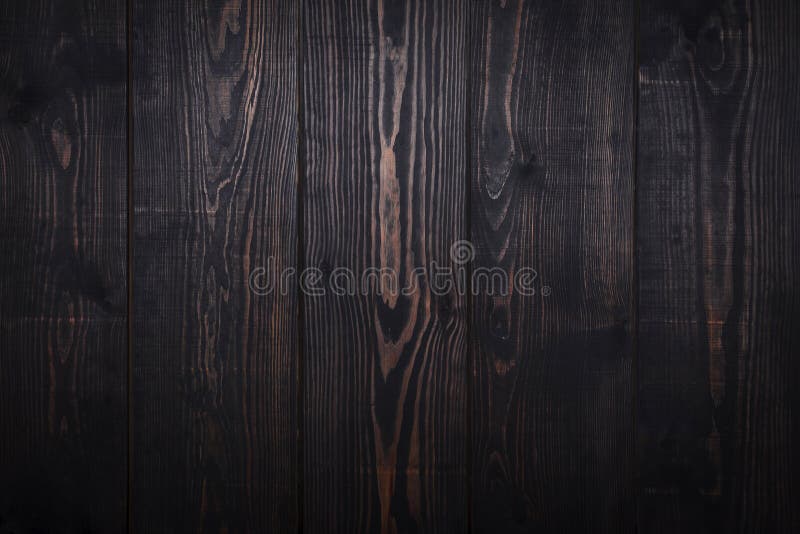 Dark brown wooden plank background.