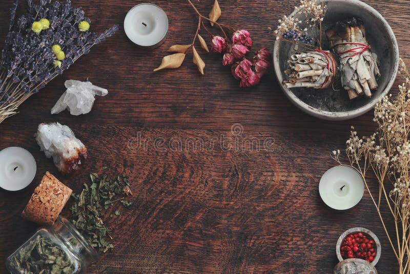 Dark brown wooden table background for text, decorated with witchy wiccan items to look esoteric and occult royalty free stock image