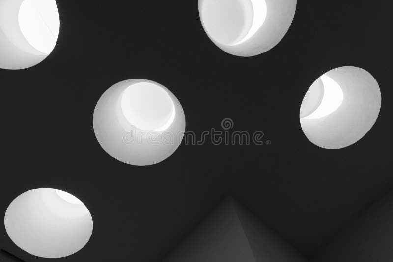 Dark ceiling with bright round skylight portals, abstract photo stock images