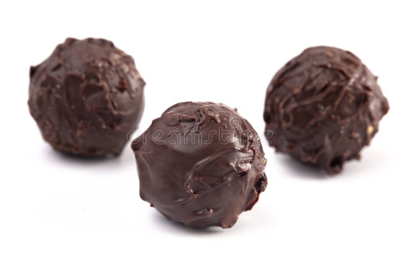 Dark Chocolate Truffles Filled with Caramel on a White Backgroun Stock