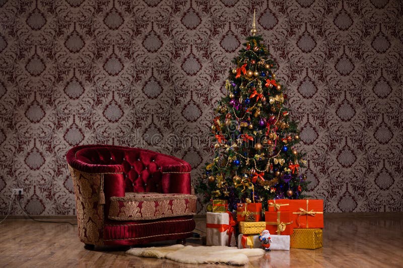 Dark Christmas scene with a decorated Christmas tree, gifts and armchair royalty free stock images Dark Christmas scene with a decorated Christmas tree, gifts and armchair royalty free stock images