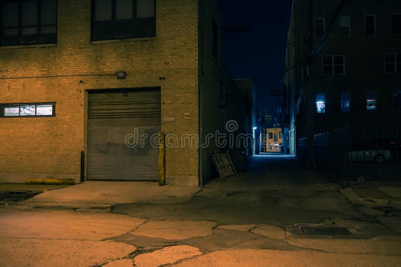 Dark city street corner and alley at night
