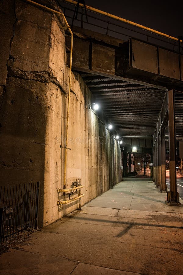 Dark urban downtown city elevated train underpass and sidewalk at night. Night train stock images, royalty-free photos and pictures