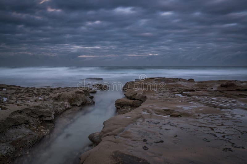 Dark clouds passing over the west coast stock image