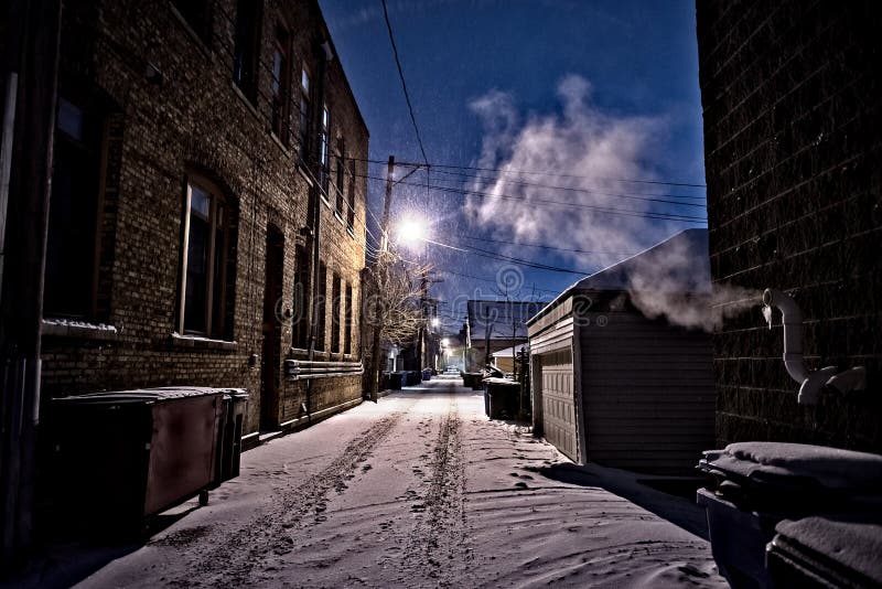 Dark, cold Chicago winter alley with snow, ice and a steaming