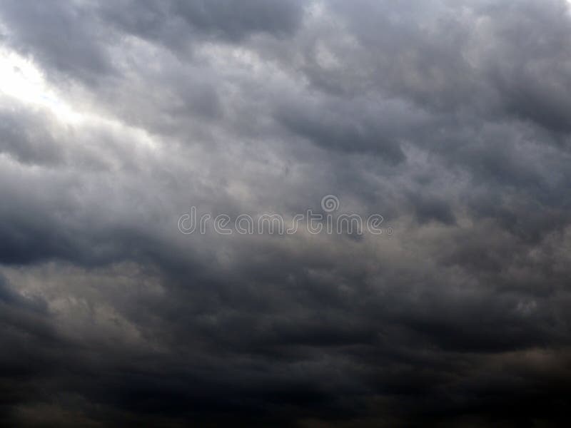 Dark gray heavy clouds in the sky before a thunderstorm. Natural gloomy sinister background. Dramatic spectacular backdrop or royalty free stock images
