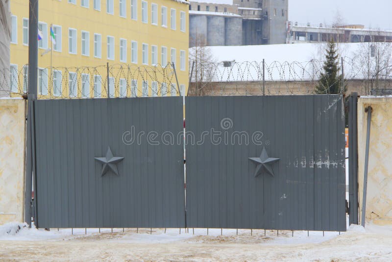 Dark gray walls with a five-pointed star and barbed wire