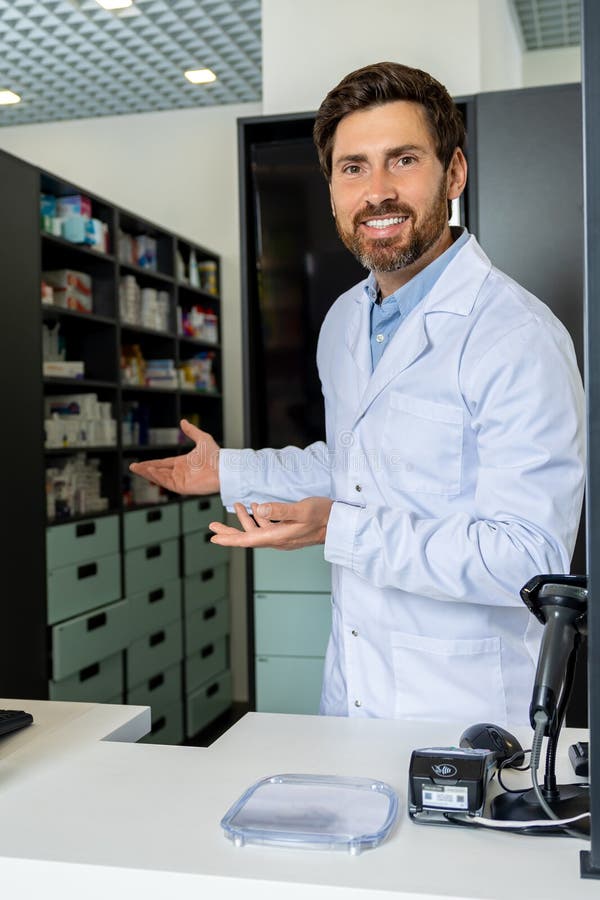 Dark-haired bearded pharmacist in a lab coat looking confident and contented stock photos