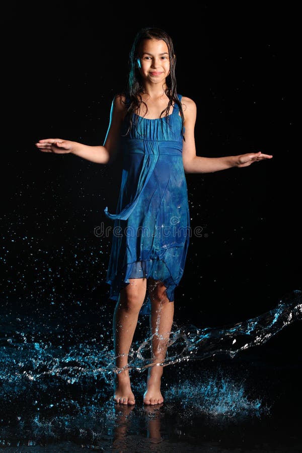 Dark-haired brown-eyed teenage girl posing in a black aqua-zone.