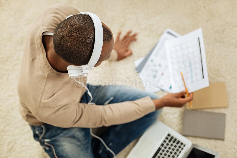 dark-haired-man-listening-to-music-while-working-stock-image-image-of