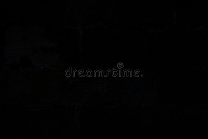 Closeup of an Old, Aged and Dark Gray, almost Black, Brick Wall. Stock