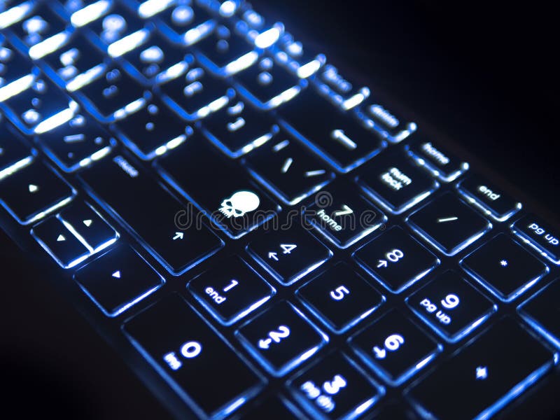 Dark keyboard with blue backlight and skull key. Dark keyboard with blue back-light and skull icon instead of enter key, angular close up view, defocused stock photos Dark keyboard with blue backlight and skull key. Dark keyboard with blue back-light and skull icon instead of enter key, angular close up view, defocused stock photos
