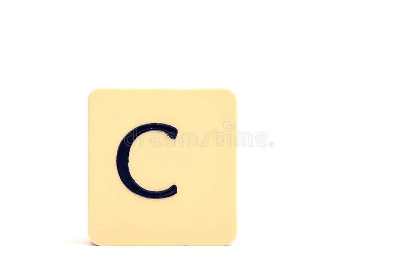 Dark Letter C on a Pale Yellow Square Block Isolated on White ...