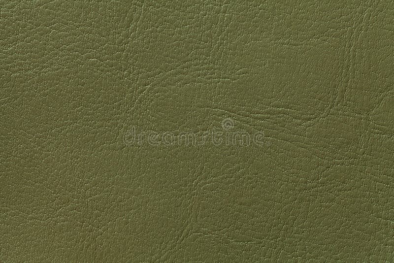 Dark olive leather texture background, closeup. Green cracked backdrop stock photography