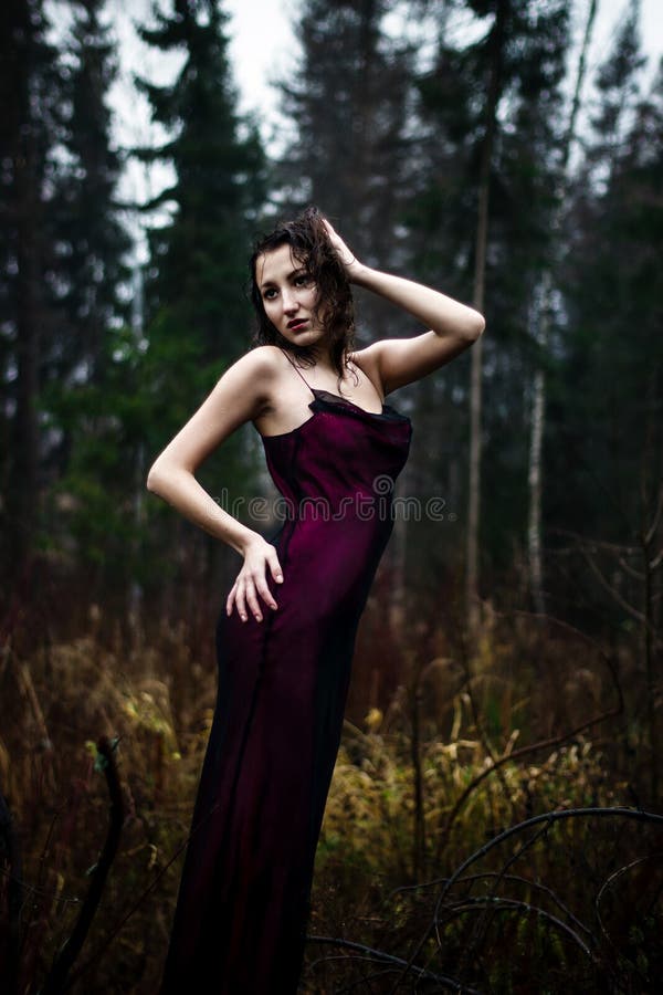 Dark portrait of woman under rain