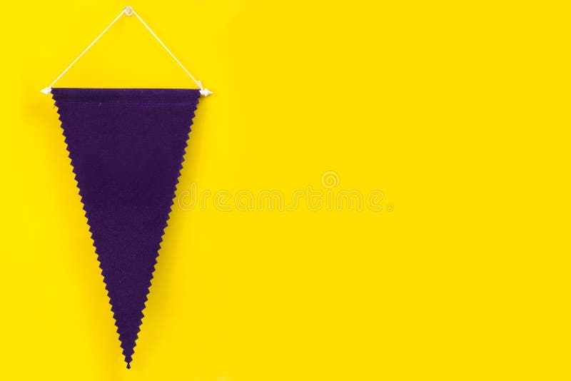Dark purple pennant hanging on yellow wall royalty free stock image