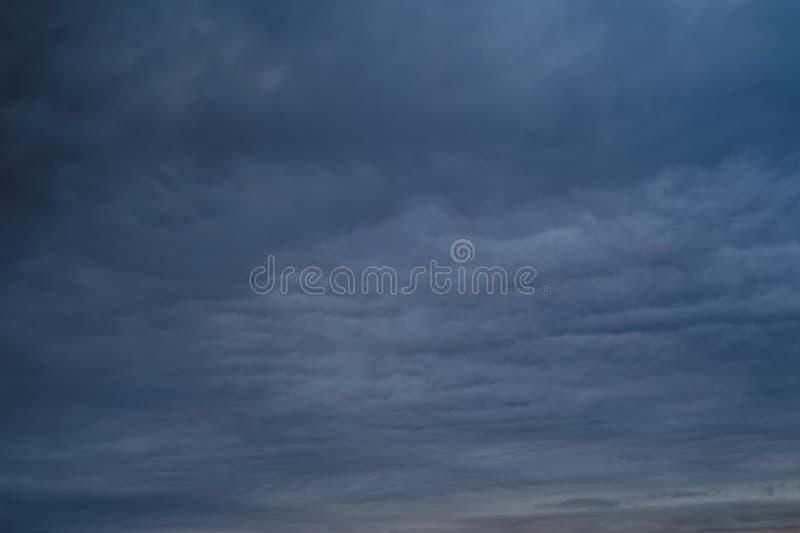 Dark Rain Clouds in the Evening Sky. Dramatic Sky with an Coming Cloudy