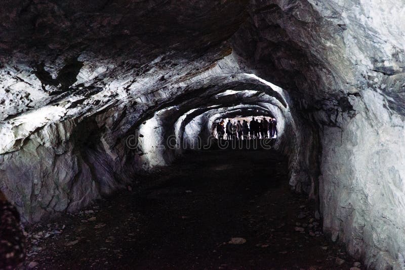 Dark and scary caves with a long tunnel royalty free stock photography Dark and scary caves with a long tunnel royalty free stock photography
